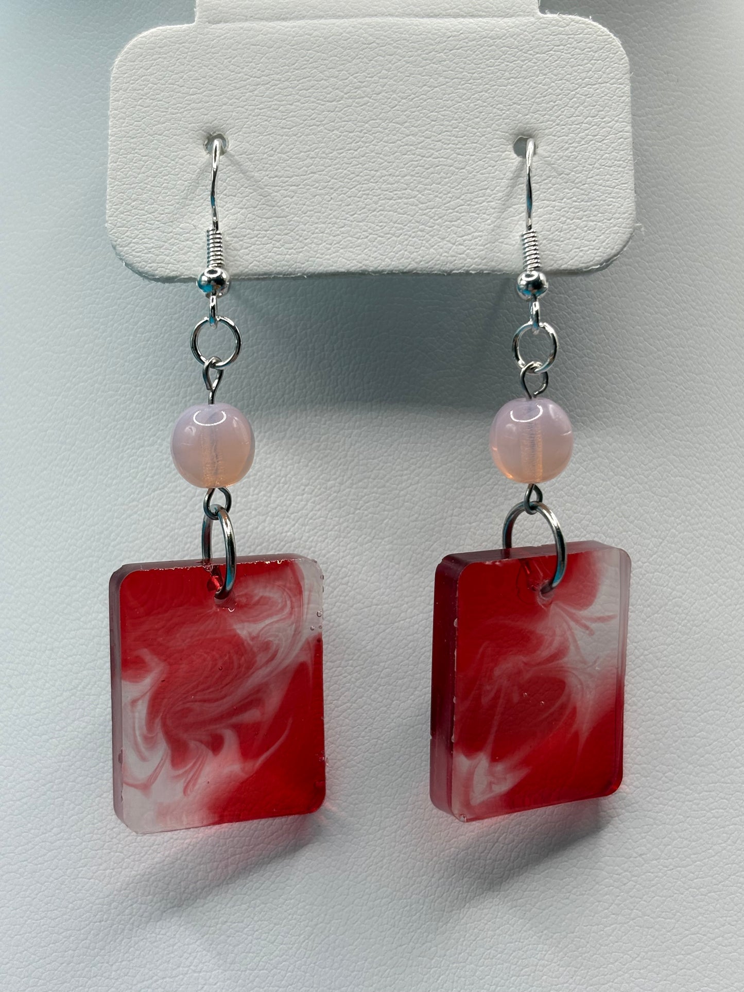 Red swirl dangle earrings